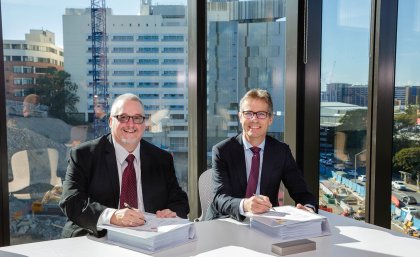 MNHHS Chief Executive Shaun Drummond and UQ Vice-Chancellor Professor Peter Høj sign the alliance agreement.