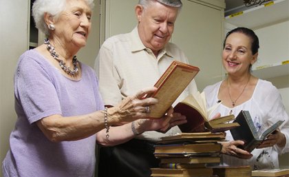 UQ Alumni Book Fair volunteers Maureen Hummel, Harry Thompson and Maria Antonatos sort books.