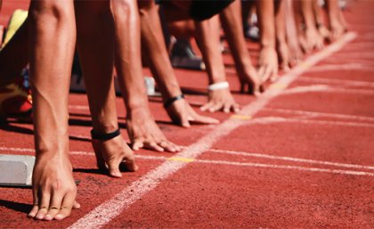 Generic image of a sprinters getting ready to start a race on an athletics track.