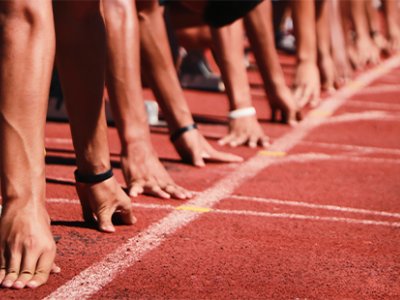 Generic image of a sprinters getting ready to start a race on an athletics track.