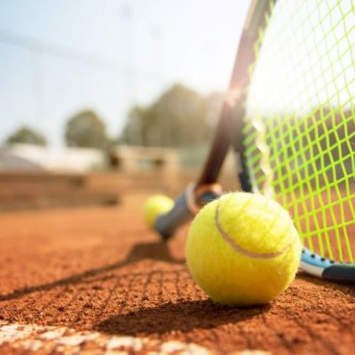 A low angle view of a tennis court, tennis racquet and ball