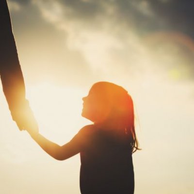 A shadow of a little girl holding a parent's hand