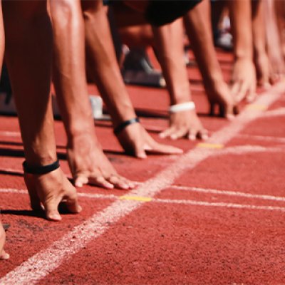 Generic image of a sprinters getting ready to start a race on an athletics track.