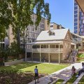 An old Queenslander house overlooking grass and a garden