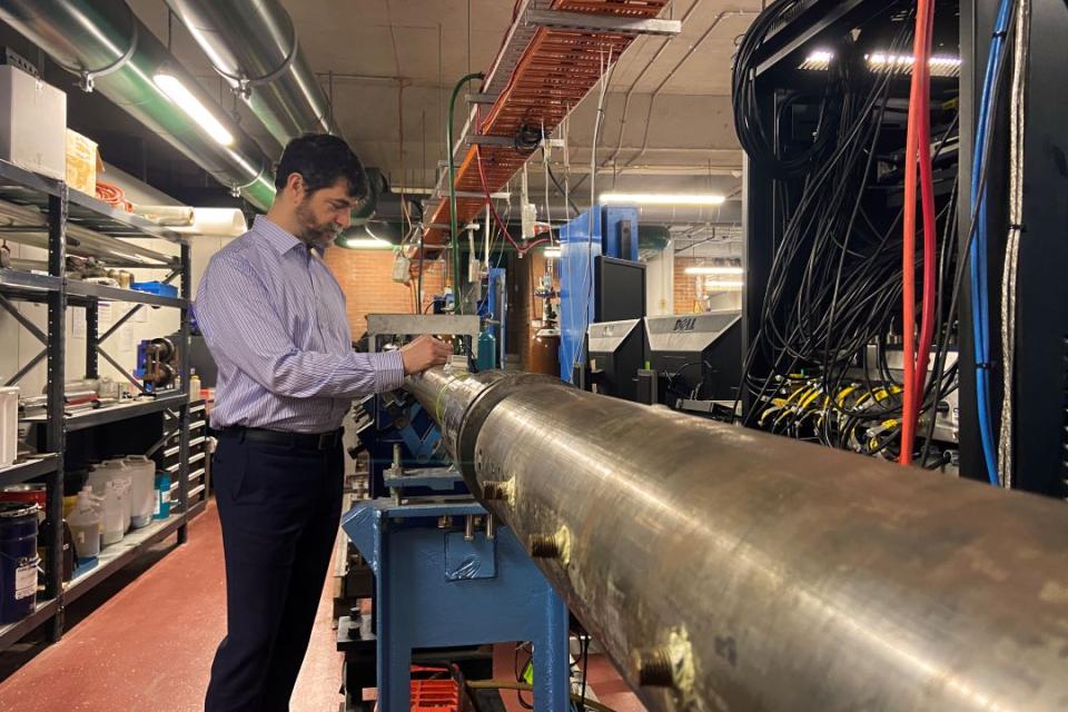 Dr David Gildfind in the UQ hypersonics lab alongside the X2 expansion tube, where the magnetic heat shield experiments will be conducted,