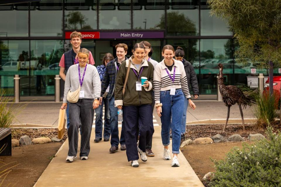 First-year medical students walking and talking outside Roma Hospital. 