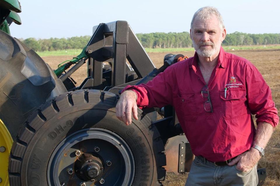 A man leaning up against a tractor