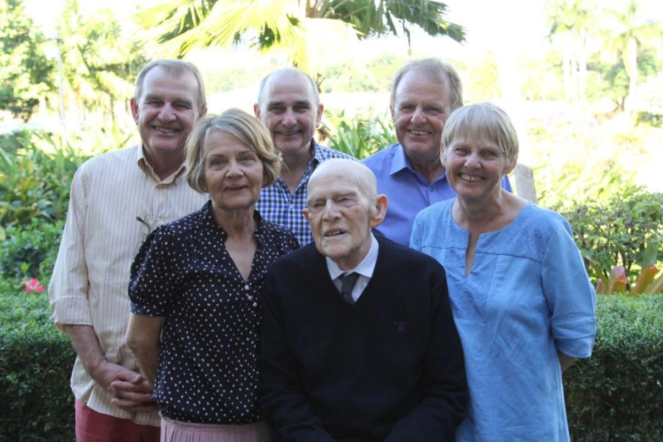 The Crawford family members pose in a garden