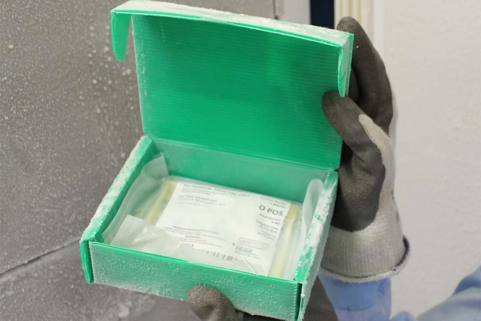 A bag of frozen blood platelets sitting in a box from the freezer.