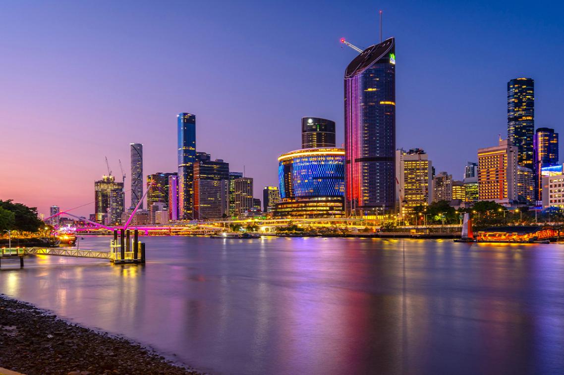 A sunset photo of the Brisbane River looking from Southbank across to the CBD.