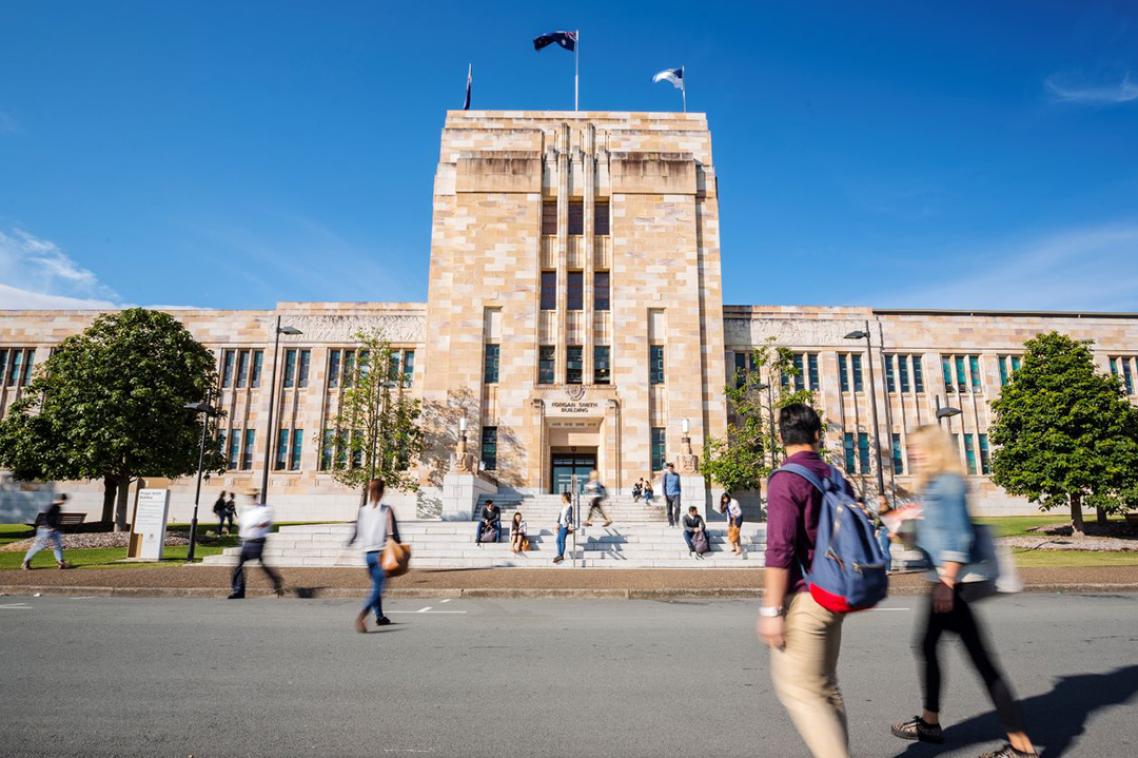Students walking towards UQ's Forgan Smith building on a sunny day.