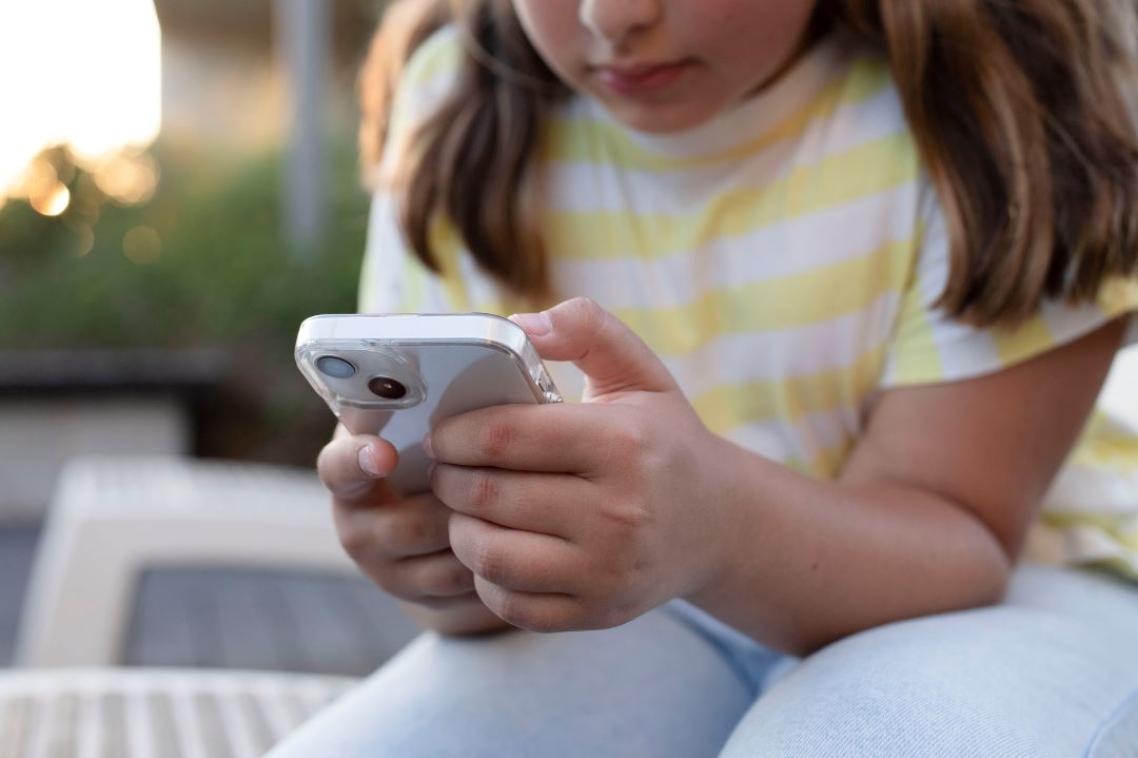 A young girl looking at her phone