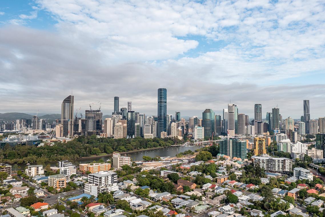 A daytime photo of Brisbane's skyline with suburbs and the CBD.