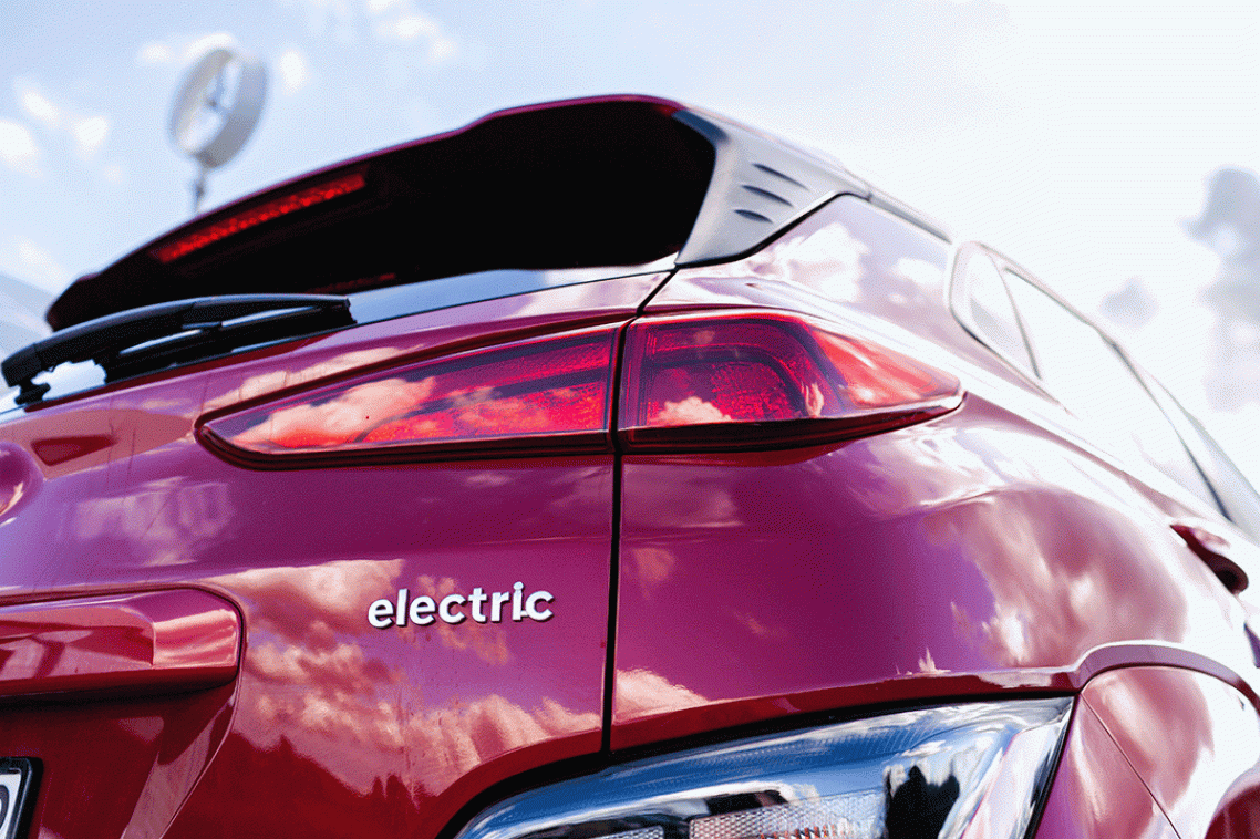 The back of a red car with the word electric across it. 
