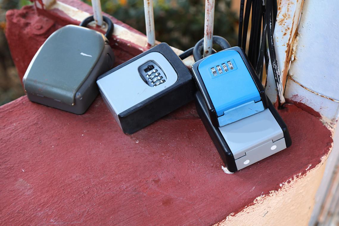 Three mechanical locks attached to a fence