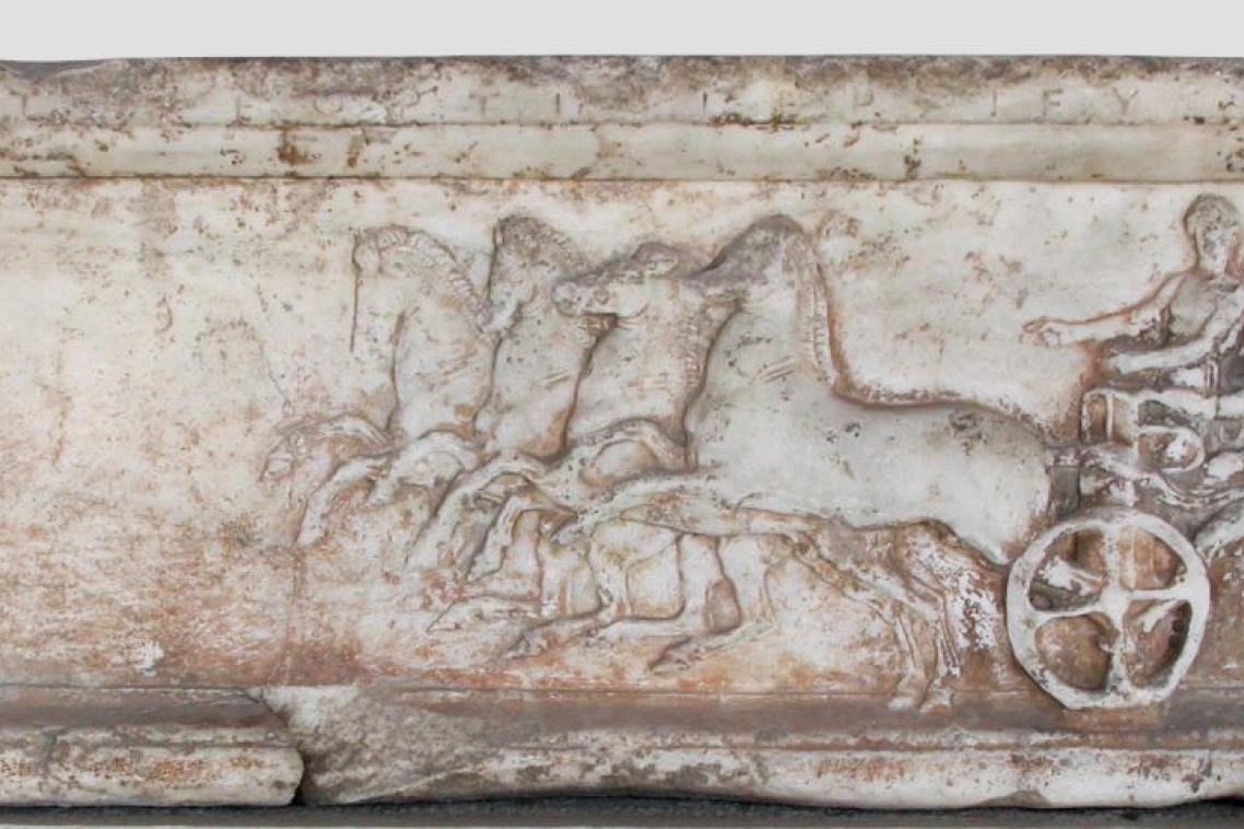 A carved illustration of a horse and carriage 
