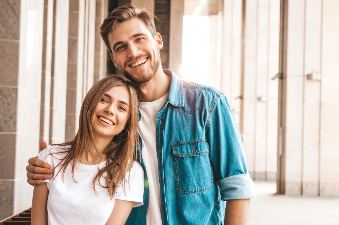 A man and a woman standing next to one another.