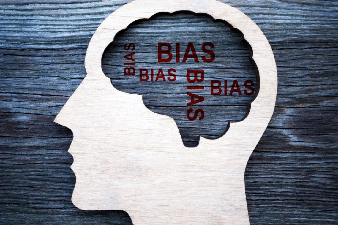 A illustration of a human with the words "bias" written where the brain would be