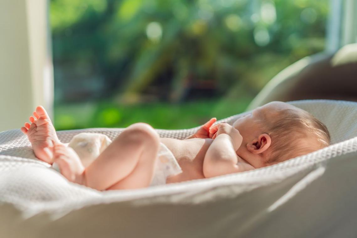 A baby lying in a crib