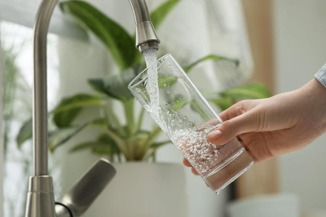 Glass being filled from kitchen tap
