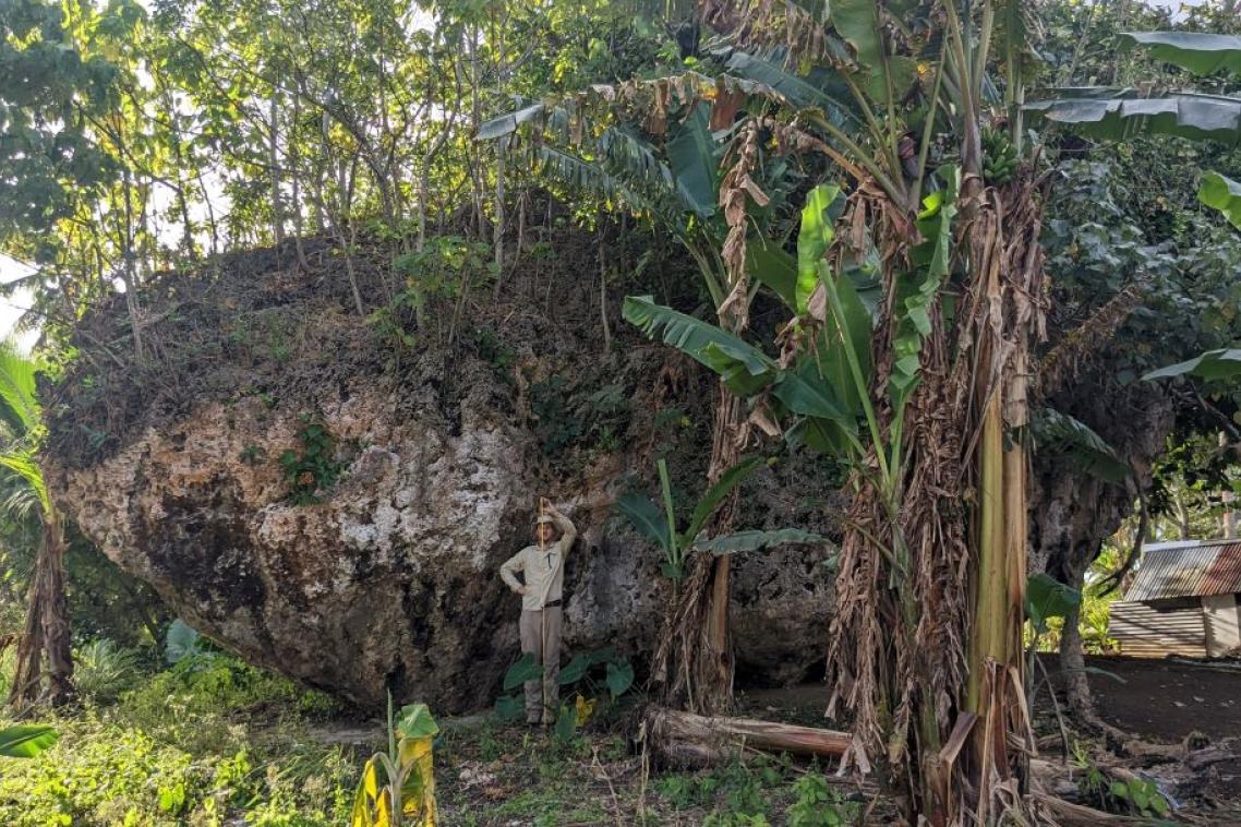 A large boulder towering over a human