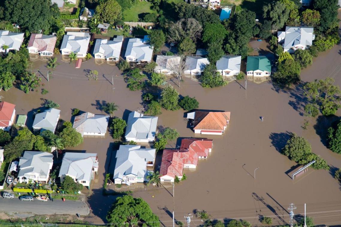 Aerial view of the rooves of houses in brown floodwater