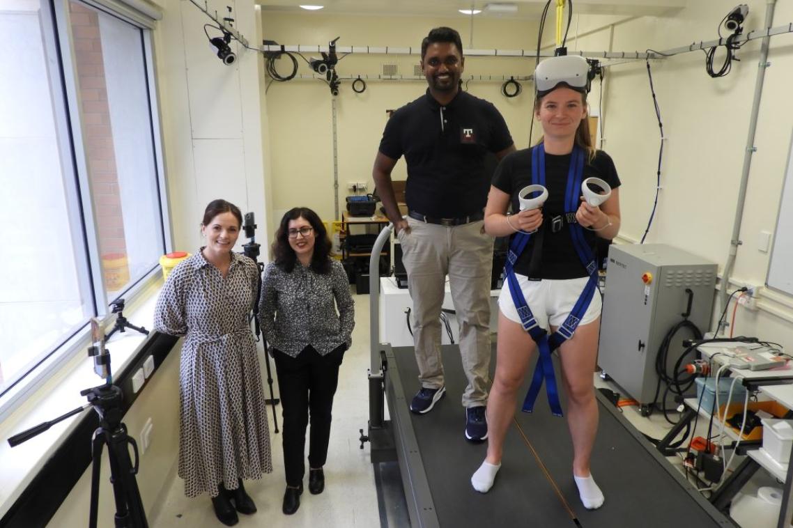 (L-R) Associate Professor Taylor Dick from the School of Biomedical Sciences, Dr Nell Baghaei from the School of Electrical Engineering, Electrical Engineering and Computer Science PhD scholar Achintha Abayasiri & research scholar Anastasia Polach in the UQ neuromuscular biomechanics laboratory with the VR balance rig.