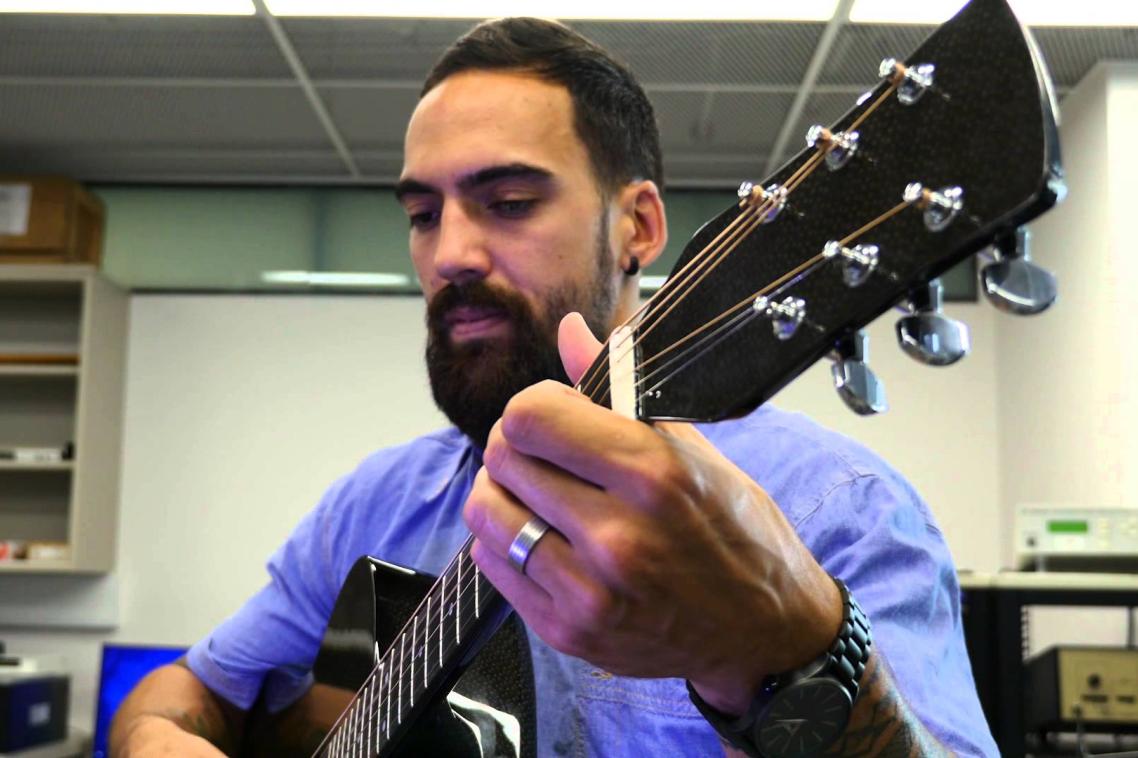 UQ student plays a carbon fibre guitar