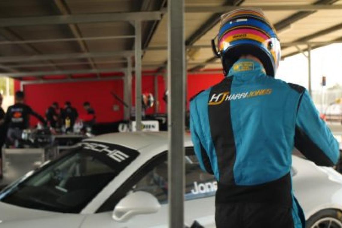Harri Jones walking to the car with a helmet on. 