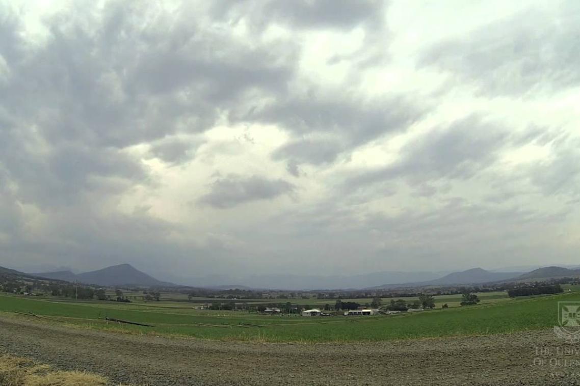 A scenic view of mountains with storm clouds rolling in