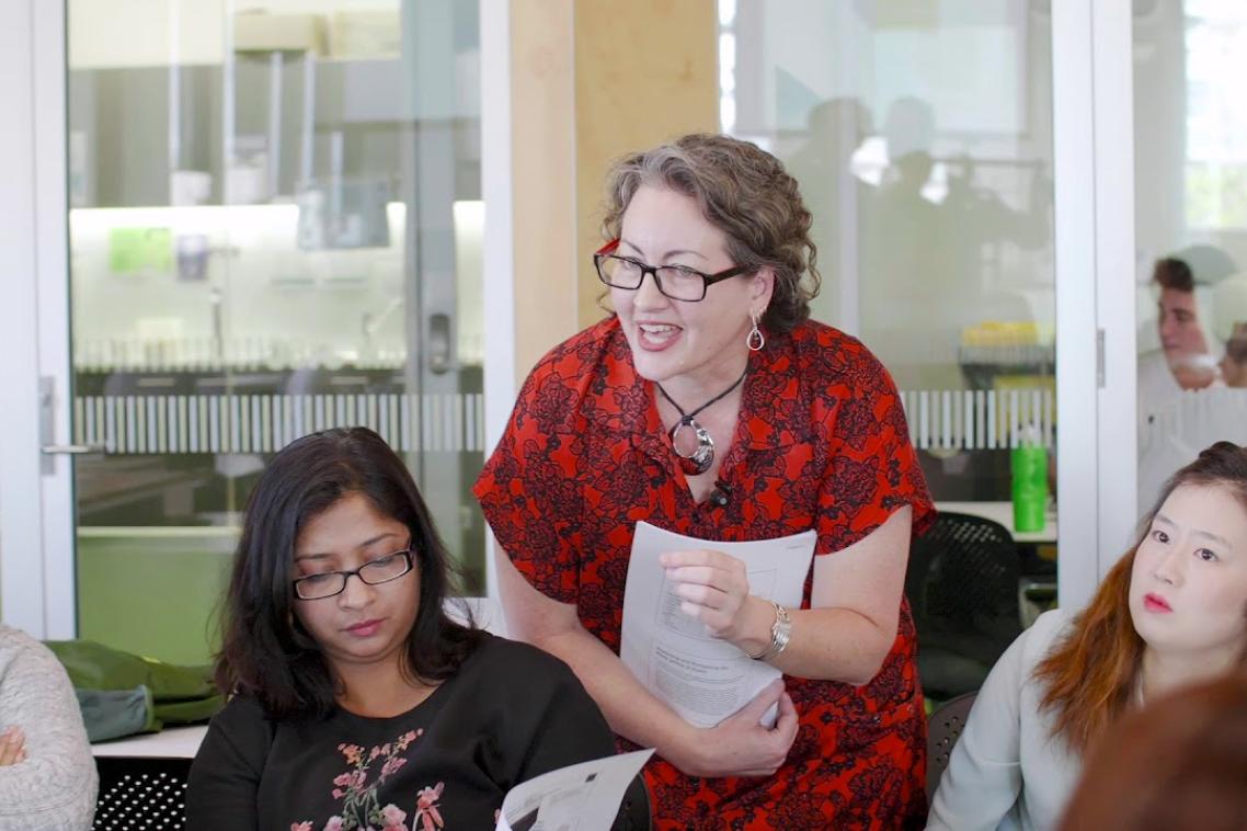 A UQ teacher surrounded by students