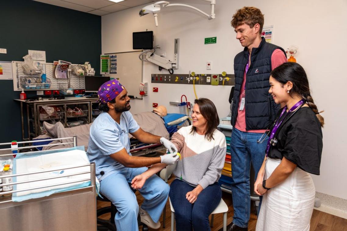 University of Queensland third year student demonstrates patient care to first year students touring Roma Hospital. 