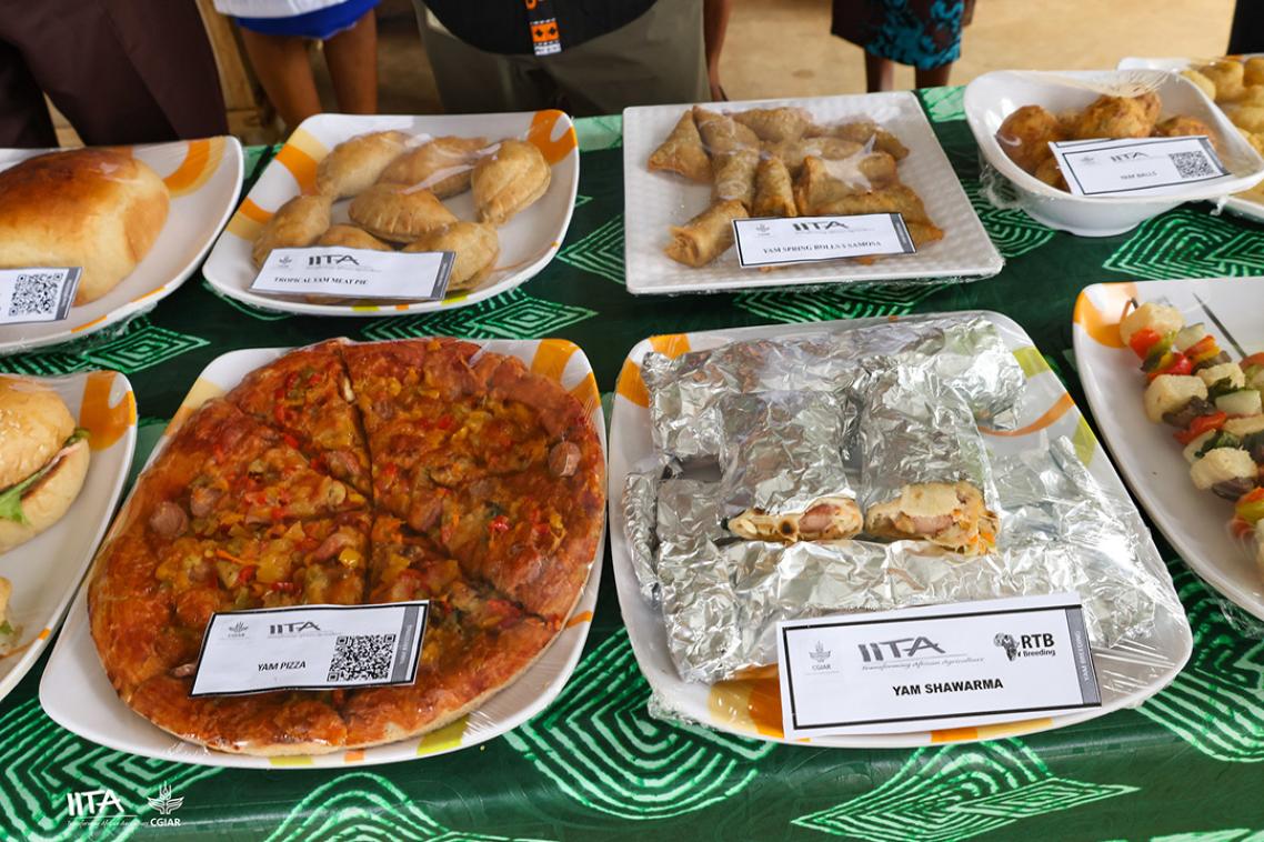 A pizza sits on a table with a green table cloth. 