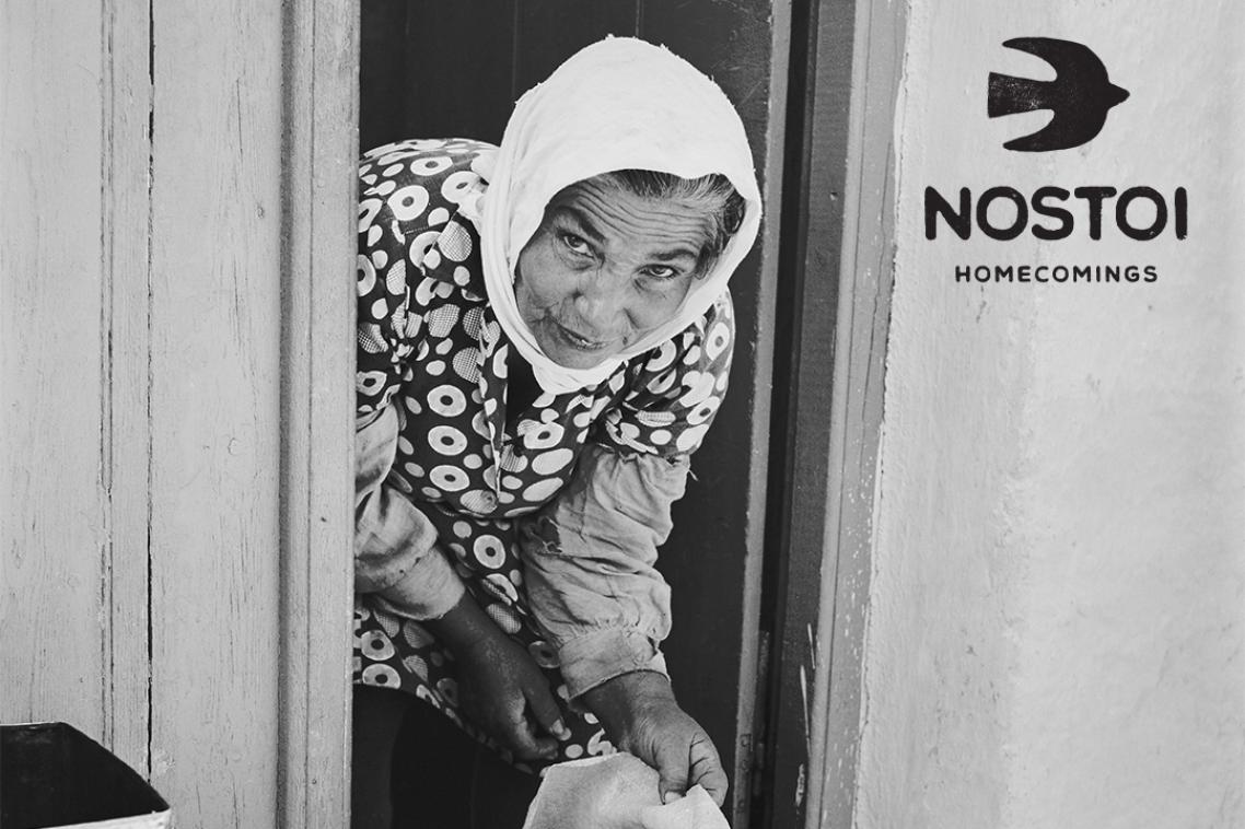 An older Greek woman from the Ionian Islands looking out her front door.
