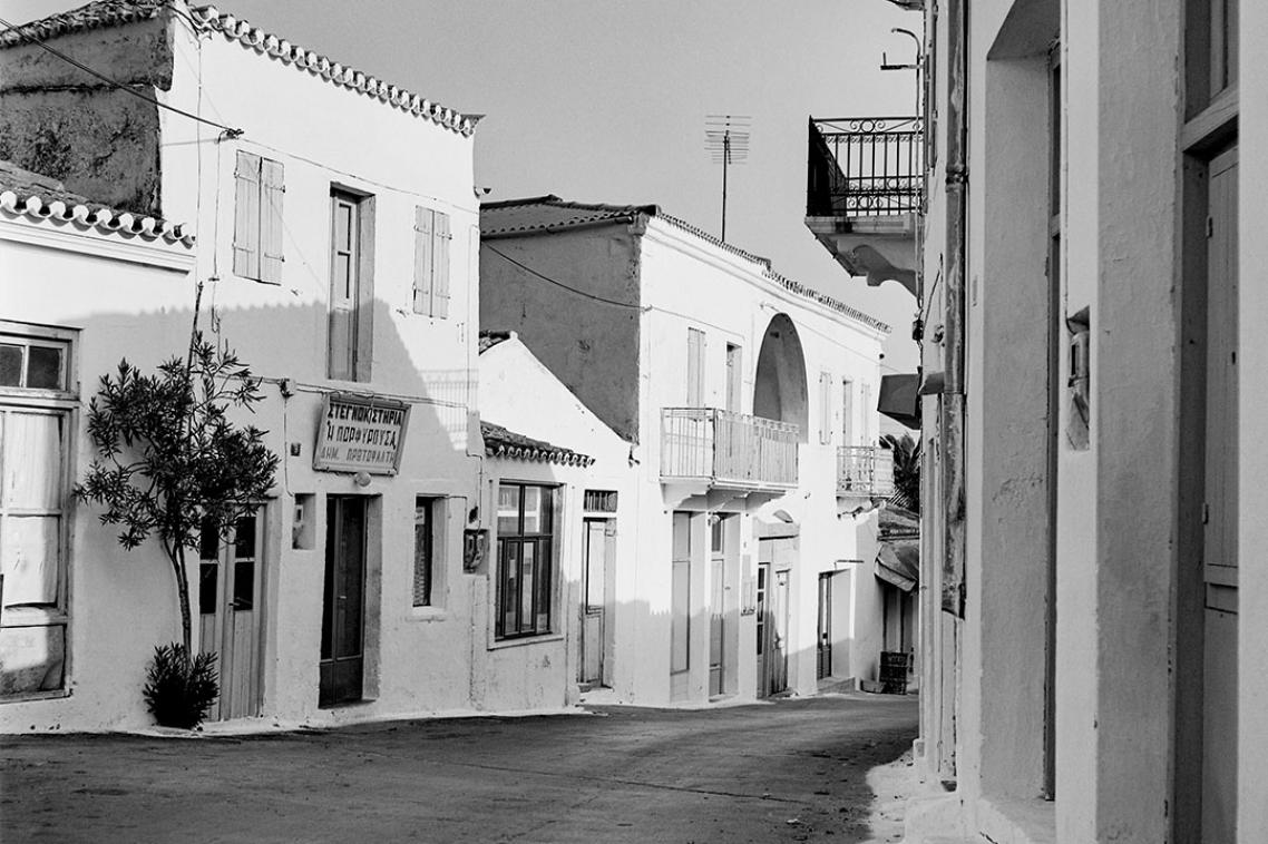 A cobblestoned street lined with houses 