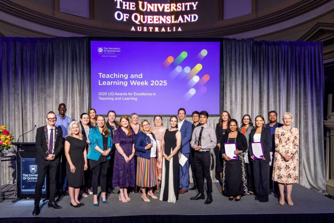 A group of people standing on a stage in front of a sign reading "Teaching and learning week 2025"