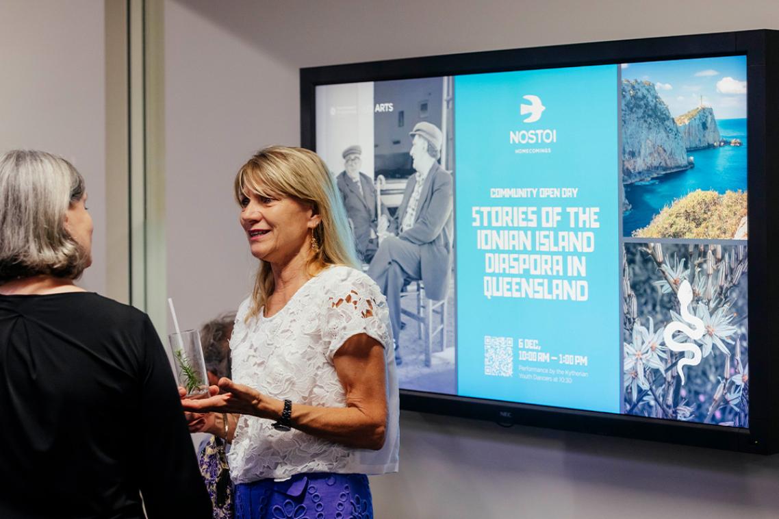Two women talking at the opening night of the exhibition.