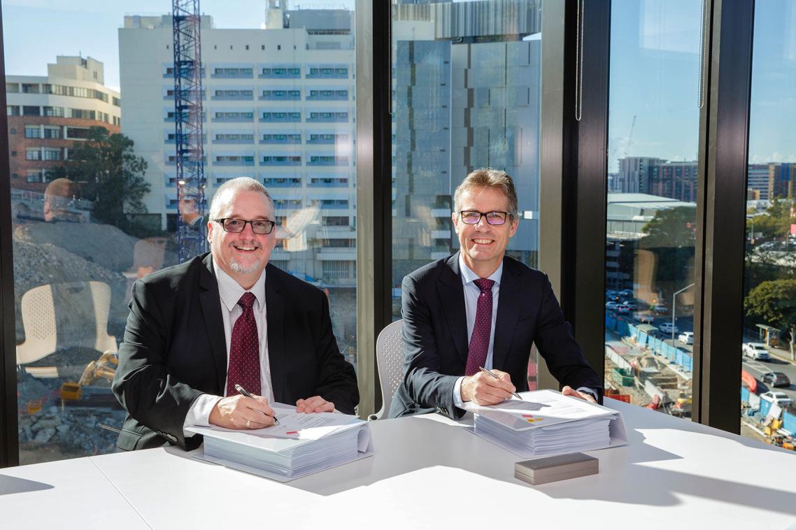 MNHHS Chief Executive Shaun Drummond and UQ Vice-Chancellor Professor Peter Høj sign the alliance agreement.