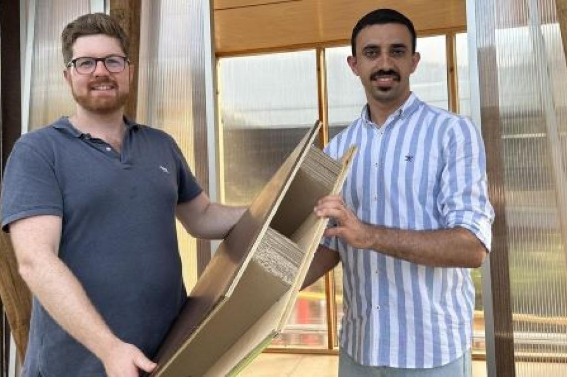 UQ researchers Associate Professor Joe Gattas (left) and PHD student Mahmoud Abu-Saleem with one of their timber-cardboard web-core sandwich (TCWS).
