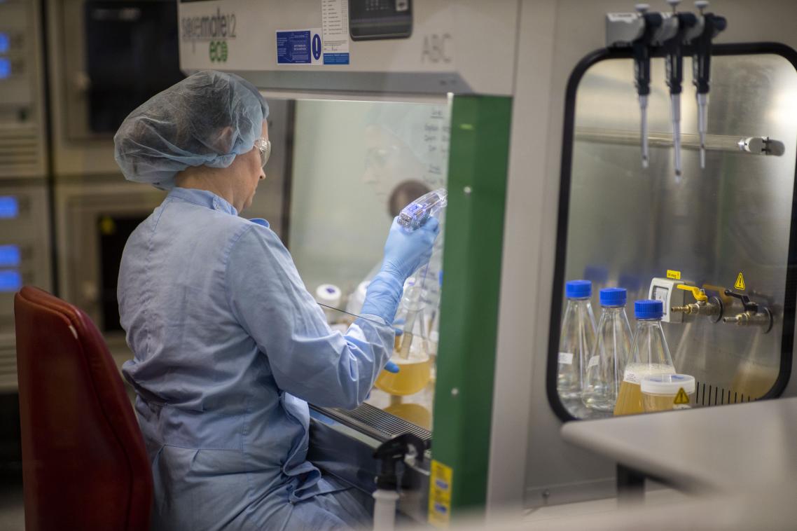 A lab scientist pipettes vaccine solution
