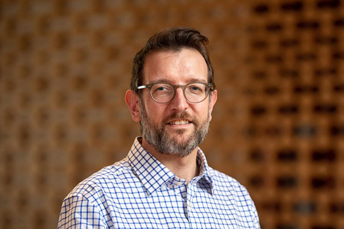 Phillip Vaughan head and shoulders in front of a brown background