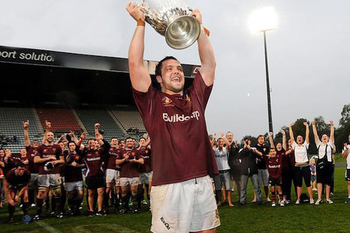 UQ Captain James Hanson holds up the Hospital Cup. Photo by Tomme Hanson