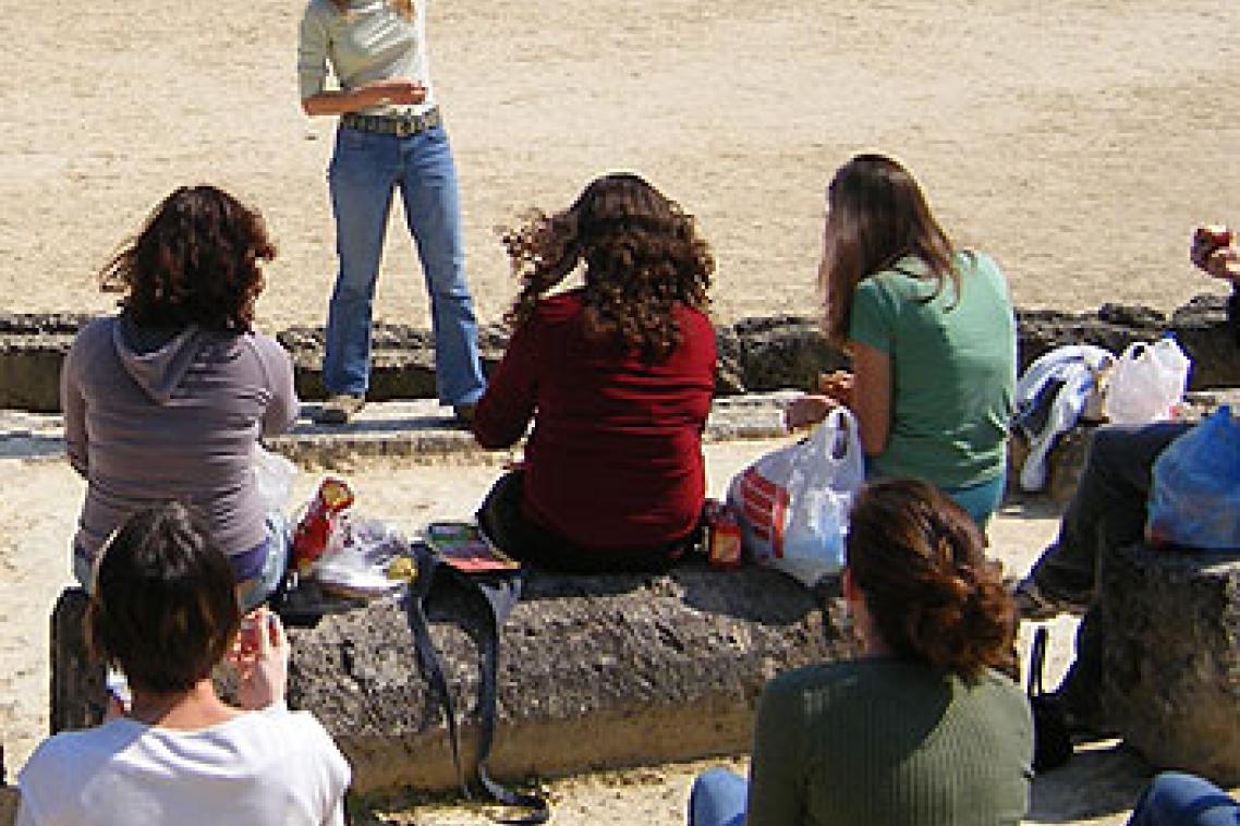 Dr Amelia Brown lecturing at an ancient stadium in Nemea, Greece