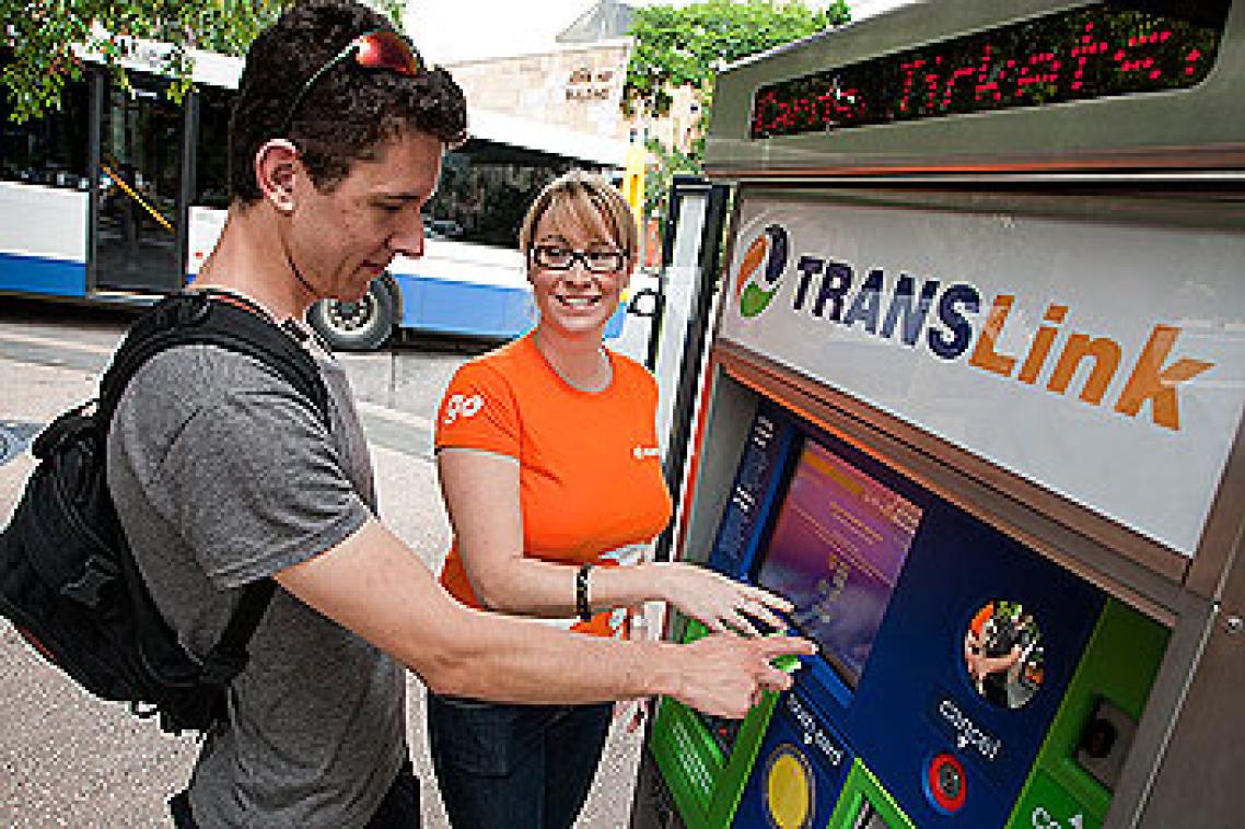 TransLink representative Jessica Brown helps Bachelor of Science student Joshua Horsley use the machine