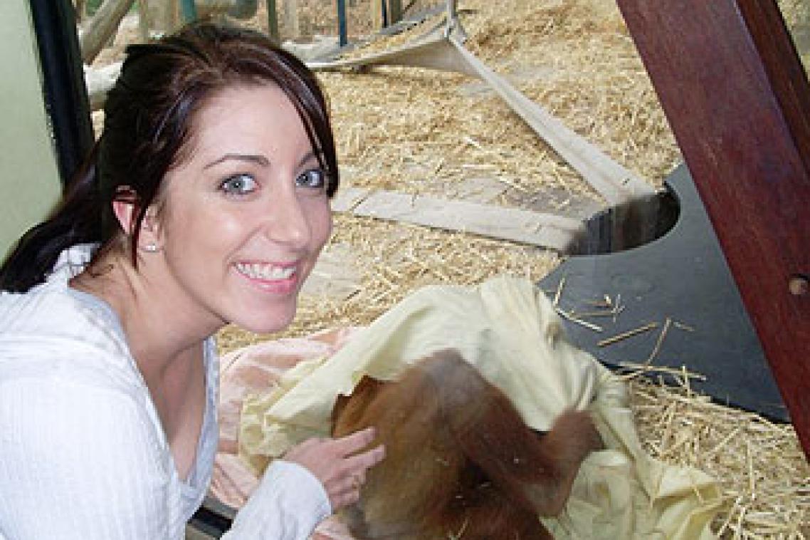 UQ student Danielle Nilsson with an orangutan at Melbourne Zoo