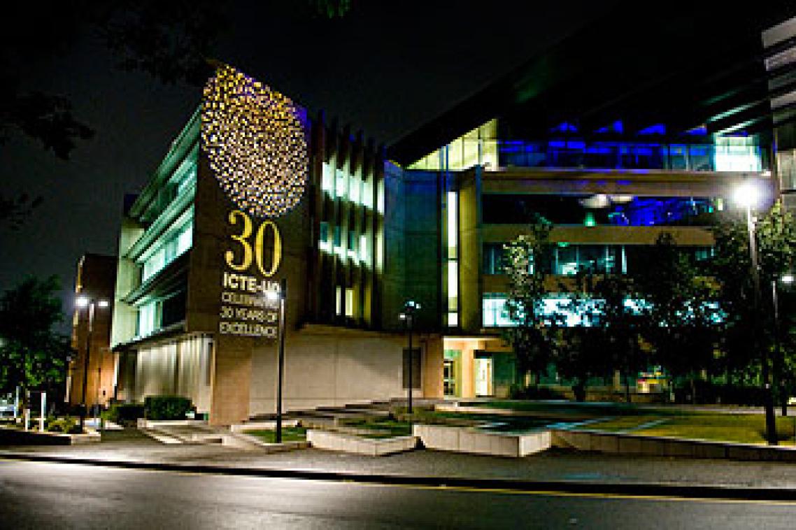The exterior of the Sir Llew Edwards Building lit to celebrate ICTE-UQ's 30th anniversary