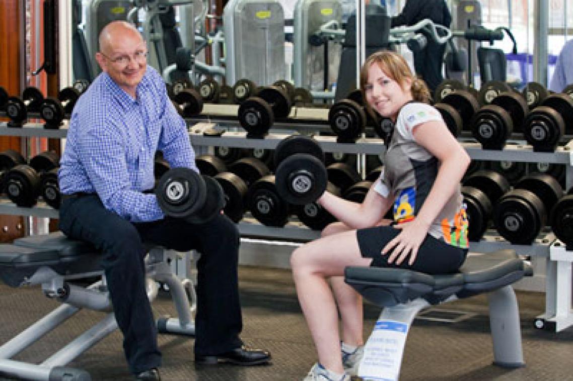 Shayne Neumann MP with UQ student and UQ Sport staff member, Courtney Bailey lifting weights in the new gym.