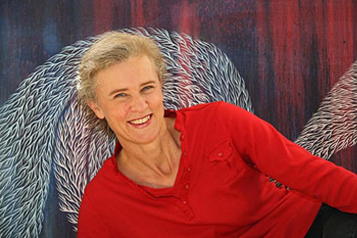 Kathryn Brimblecombe-Fox in front of one of her artworks