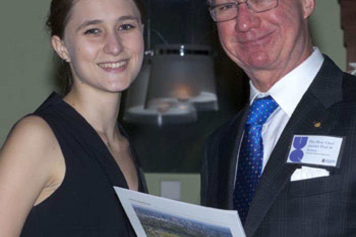 Chief Justice of Queensland Paul de Jersey AC presents the Dr MHM Kidwai Memorial Prize to UQ law student Tegan Stockdale.
