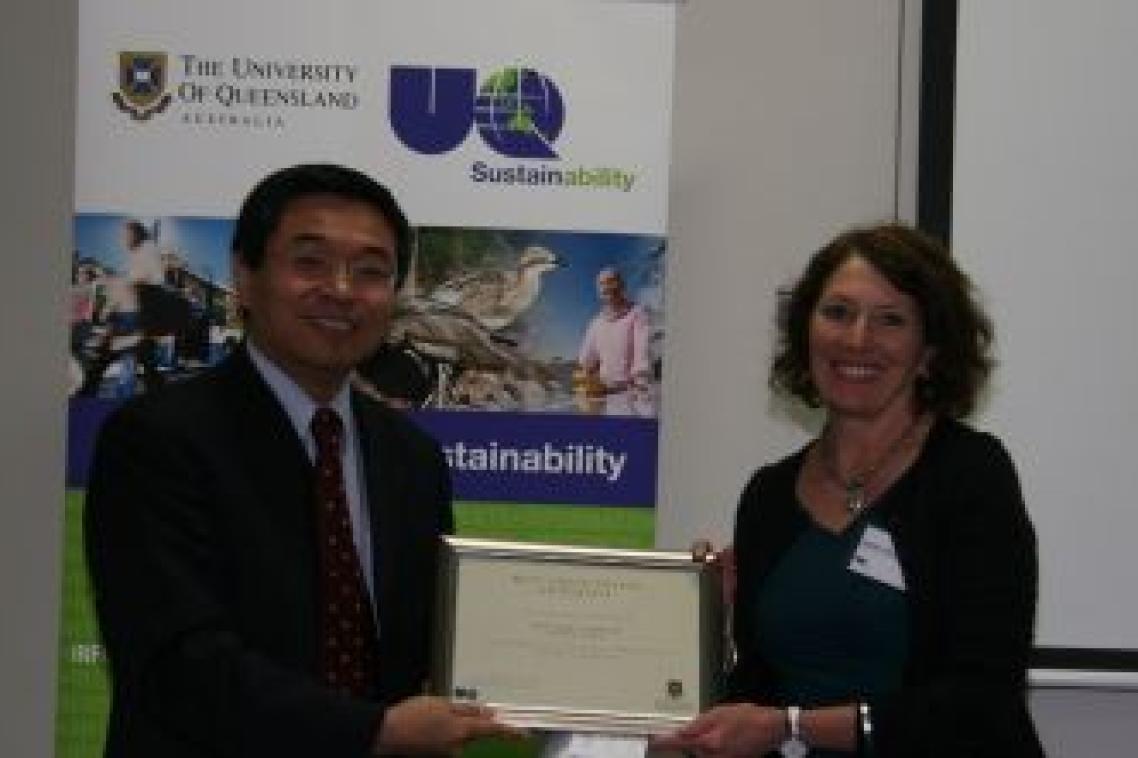 Jenny Hall of the UQ Dentistry Library receives an award for the Best Green Office Initiative from Senior Deputy Vice-Chancellor Professor Max Lu. Photo: Stuart Green